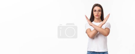 Photo for Waist-up portrait of determined, serious-looking young female activist, saying no to women opression, show cross sign in stop motion, look determined, quit something, prohibit or disapprove. - Royalty Free Image