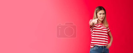 Photo for Girl plead you guilty. Upset asian blond girlfriend being cheated on pointing camera blame person make accusations, frowning disappointed and hurt, stand red background bothered offended. - Royalty Free Image