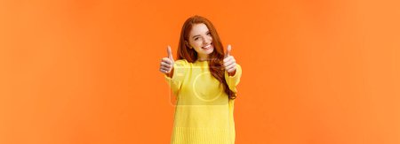 Good luck. Optimistic, confident cute redhead girlfriend encourage you, giving thumbs-up in like or approval, smiling rate excellent movie or product, give positive feedback, recomment, orange wall.