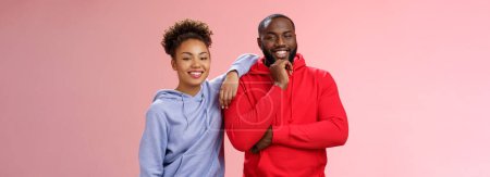 Lifestyle. Romantic couple best friends standing pink background girl leaning boyfriend shoulder smiling broadly feel love respect each other working team standing pleased delighted friendly look