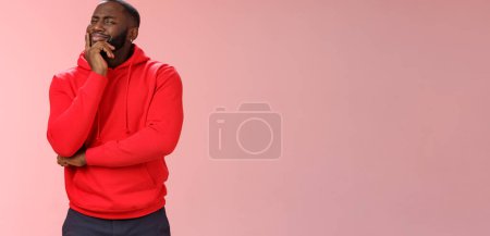 Photo for Doubtful sceptical young african-american hesitant bearded guy frowning sarcastic unsure touching chin thoughtful having bad feeling about idea, look disbelief camera, standing pink background. - Royalty Free Image