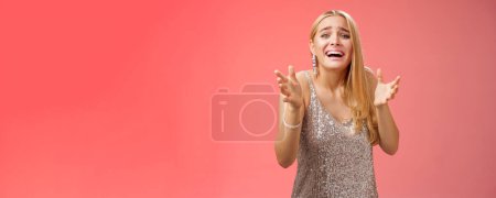 Photo for Lifestyle. Panicking upset miserable heartbroken blond girl crying raising hands begging not go broke-up boyfriend look sorrow distressed freak-out standing devastated red background during party. - Royalty Free Image