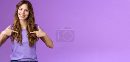 Photo for Cheerful motivated professional assertive curly woman pointing herself center smiling broadly propose own help wanna participate boastful talking accomplishments stand purple background. - Royalty Free Image