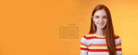 Photo for Lifestyle. Pleasant friendly-looking confident smart redhead female student aim success smiling self-assured express lucky positive upbeat mood casually hang out orange background listening amusing - Royalty Free Image