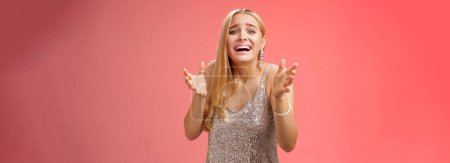 Photo for Lifestyle. Panicking upset miserable heartbroken blond girl crying raising hands begging not go broke-up boyfriend look sorrow distressed freak-out standing devastated red background during party. - Royalty Free Image