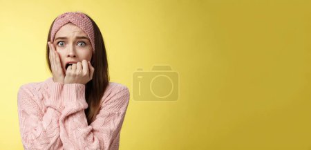 Photo for Shocked frightened stunned cute timid girl panicking, standing in stupor biting fist in fear staring terrified pressing palm to chest worried, upset, innocent woman become witness of crime stupefied. - Royalty Free Image