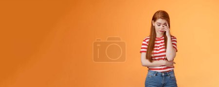 Photo for Annoyed redhead woman fed up listening stupid nonsense, close eyes tired, make face palm embarrassed uninterested, feel uneasy distressed, exhausted useless argument, irritated orange background. - Royalty Free Image