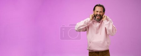 Photo for Annoyed fed up pressured caucasian adult man bearded yelling pissed close eyes cringing disgust annoyance close ears bothered cannot stand loud awful noise, grimacing shouting turn off music. - Royalty Free Image
