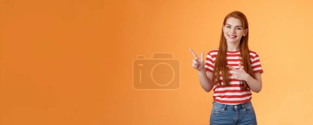 Photo for Cheerful pleasant female professional assistant showing customers office, pointing left smiling cheerful, gladly help out pick product, introduce new promos copy space, stand orange background. - Royalty Free Image