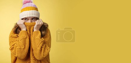 Photo for Offended sad whining cute tender young girl hiding face pull sweater nose peek look aside insulted complaining being insulted, standing miserable upset wearing warm winter corduroy hat. - Royalty Free Image