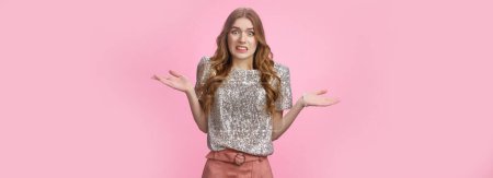 Photo for Awkward confused glamour party girl shrugging hands spread sideways dismay grimacing unaware, cannot get clue standing uncertain apologizing accidently bumping car, standing pink background. - Royalty Free Image