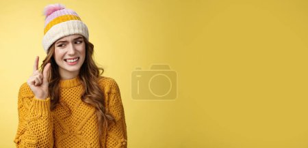 Photo for Displeased attractive picky woman describing small object show tiny thing cringing dislike disappointment look upset fingers, describing little salary new job, standing yellow background awkward. - Royalty Free Image