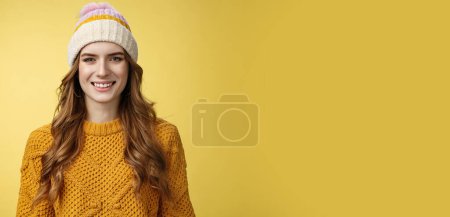 Photo for Attractive young friendly-looking outgoing girl dressed warm travel mountains skiing having fun spend winter holidays alps family, smiling broadly wearing corduroy hat sweater, yellow background. - Royalty Free Image