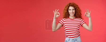 Photo for Motivated ambisious good-looking empowered young redhead curly girl assuring everything excellent show okay ok perfection gesture smiling assertive confidently approve like awesome choice. - Royalty Free Image