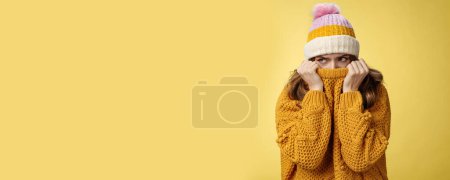 Photo for Offended sad whining cute tender young girl hiding face pull sweater nose peek look aside insulted complaining being insulted, standing miserable upset wearing warm winter corduroy hat. - Royalty Free Image