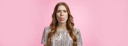 Photo for Moody immature cute glamour rich spoiled girl stick out tongue expressing dislike reluctance cringing frowning disappointed, offended boyfriend, standing dissatisfied pink background. - Royalty Free Image