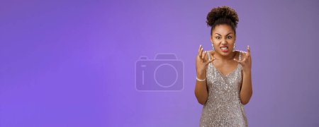 Photo for Annoyed pissed arrogant freak-out african american woman. in silver dress squeeze fists angry frowning grimacing anger furiously look camera bothered yell rage react outrageous disrespect. - Royalty Free Image