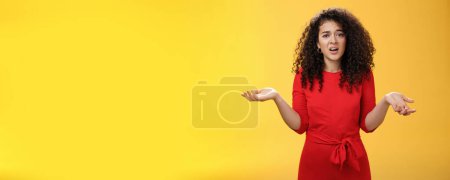 Photo for What your problem. Annoyed and confused pissed girlfriend with curly hair in elegant party dress shrugging with hands spread sideways and clueless grimace, waiting explanation during argument. - Royalty Free Image