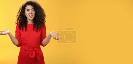 Photo for What your problem. Annoyed and confused pissed girlfriend with curly hair in elegant party dress shrugging with hands spread sideways and clueless grimace, waiting explanation during argument. - Royalty Free Image