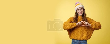 Photo for Girl brings peace love show heart gesture tilting head friendly smiling expressing sympathy passion confessing boyfriend warm feelings, heartbit sign, grinning flirty, standing yellow background. - Royalty Free Image