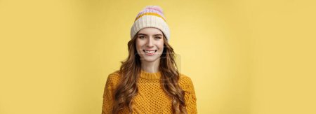 Photo for Attractive young friendly-looking outgoing girl dressed warm travel mountains skiing having fun spend winter holidays alps family, smiling broadly wearing corduroy hat sweater, yellow background. - Royalty Free Image
