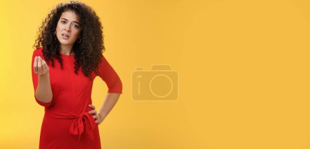 Foto de Girl being pissed off arguing ad complaining making italian what do you want gesture looking bothered waiting for explanation as standing annoyed and fed up over yellow background. Negative emotions - Imagen libre de derechos