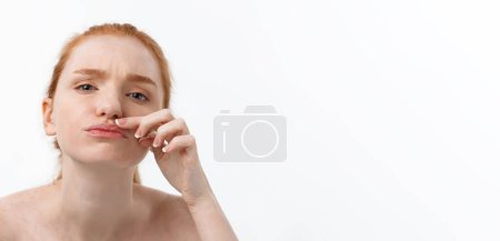 Photo for Young caucsian woman squeezes acne on the face of beauty. - Royalty Free Image
