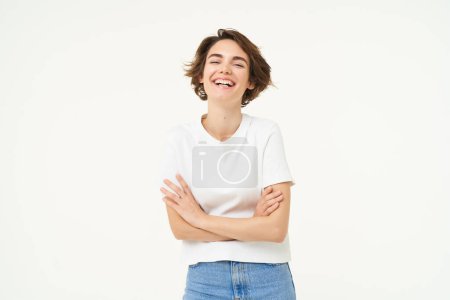 Photo for Portrait of cheerful woman laughing and smiling, cross arms on chest, standing in confident power pose, young professional concept, white studio background. - Royalty Free Image