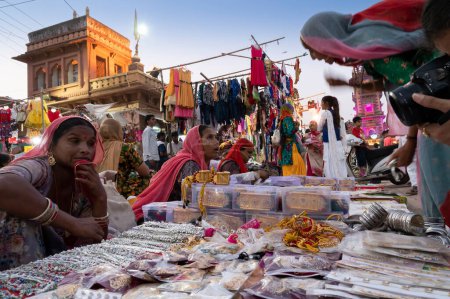 Photo for Jodhpur, Rajasthan, India - 19.10.2019 : Rajasthani women are buying bangles and jewelry at famous Sardar Market and Ghanta ghar Clock tower in Jodhpur, Rajasthan, India. - Royalty Free Image
