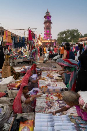 Photo for Jodhpur, Rajasthan, India - 19.10.2019 : Rajasthani women are buying bangles and jewelry at famous Sardar Market and Ghanta ghar Clock tower in Jodhpur, Rajasthan, India. - Royalty Free Image