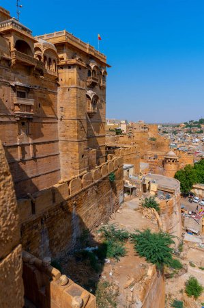 Photo for Jaisalmer, Rajasthan, India - 15th October 2019 : Sandstone made beautiful balcony, jharokha, stone window and exterior of Jaisalmer fort. UNESCO World heritage site overlooking Jaisalmer city. - Royalty Free Image