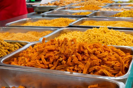 Photo for Bhujia, a spicy deep-fried sev filled with a burst of flavors, made using gram flour, moth flour, and different spices, crispy & crunchy traditional namkeen being sold in Jodhpur, Rajasthan, India. - Royalty Free Image