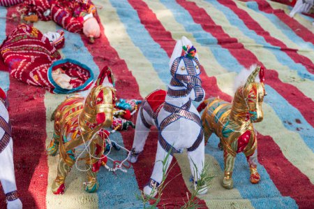 Photo for Hand made Rajasthani colourful dolls of horses, displayed for sale at Mehrangarh Fort, Jodhpur, Rajasthan. Famous for colors and little dolls represent colors spread all across Rajasthan. - Royalty Free Image