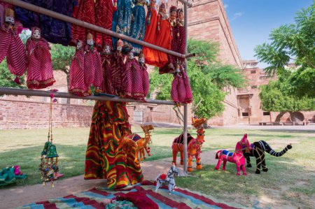 Photo for Hand made Rajasthani colourful dolls of Raja Rani,Camel,horse and elephant displayed for sale at Mehrangarh Fort, Jodhpur, Rajasthan. Little dolls represent vibrant colors spread all across Rajasthan. - Royalty Free Image