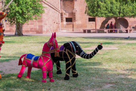 Photo for Hand made Rajasthani colourful dolls of horse and elephant displayed for sale at Mehrangarh Fort, Jodhpur, Rajasthan. Famous for colors and little dolls represent colors spread all across Rajasthan. - Royalty Free Image