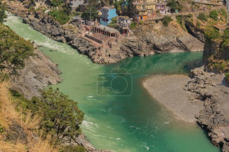 Photo for Bhagirathi river from left side and Alakananda river with turquoise blue colour from right side converge at Devprayag,Holy conflunece and form river Holy Ganges thereafter.Garhwal, Uttarakhand, India. - Royalty Free Image