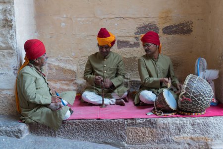 Jodhpur, Rajasthan, India - 18th October 2019: Rajasthani male folk music artist with troup in traditional dress, playing musical instruments at Meharngarh fort. Various musical instruments played.