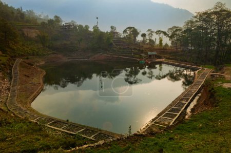 Photo for Sun reflection on water of Chayatal or Chaya Taal, West Sikkim, India, Famous for Reflection of snow-capped Mount Kanchenjunga and Kabru on lake water, Himalayan mountains and forest surrounding. - Royalty Free Image