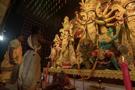 Photo for Howrah, West Bengal, India - 3rd October, 2022 : Hindu Priests worshipping Goddess Durga with panchapradip and chamor. Ashtami puja aarati - sacred Durga Puja ritual - festival of Hinduism, at night. - Royalty Free Image