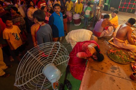 Photo for Howrah, West Bengal, India - 3rd October, 2022 : Hindu devotees praying to Goddess Durga inside puja pandal for Ashtami puja aarati. Sacred Durga Puja ritual-festival of Hinduism, at night. - Royalty Free Image