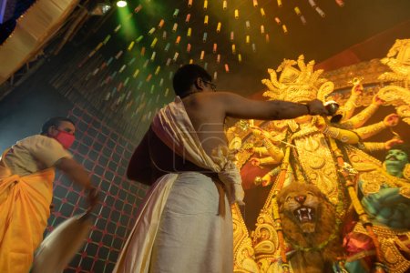 Photo for Howrah, West Bengal, India - 3rd October, 2022 : Hindu Priests worshipping Goddess Durga with pradip. Ashtami puja aarati - sacred Durga Puja ritual- festival of Hinduism being performed at night. - Royalty Free Image