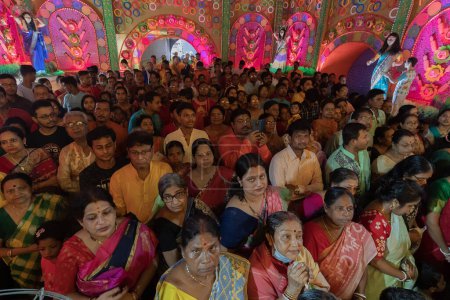 Photo for Howrah,West Bengal,India- 3rd October, 2022 : Hindu devotees praying and worshipping Goddess Durga, inside decorated Durga Puja Pandal at night. Durga puja is unesco intangible cultural heritage. - Royalty Free Image