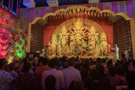 Photo for Howrah,West Bengal,India- 4th October, 2022 : Hindu devotees praying and worshipping Goddess Durga, inside decorated Durga Puja Pandal at night. Durga puja is unesco intangible cultural heritage. - Royalty Free Image