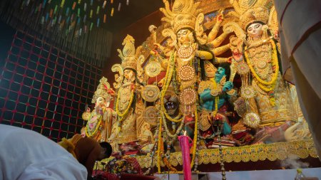 Photo for Howrah,West Bengal,India-5th October, 2022 : Hindu Purohit showing respect, praying and worshipping Goddess Durga, kneels down position. Puja Pandal. Durga puja is unesco intangible cultural heritage. - Royalty Free Image