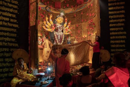 Photo for Howrah, West Bengal, India - 3rd October, 2022 : Hindu Purohit worshipping Goddess Durga with Vog, offering holy food for the Goddess behind cover. Durga Puja ritual. Biggest festival of Hinduism. - Royalty Free Image
