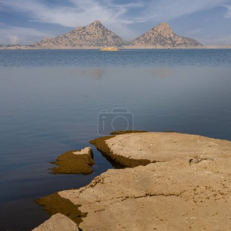 Photo for View of pristine landscape of Jawai Dam with hills and clouds in the background - Royalty Free Image