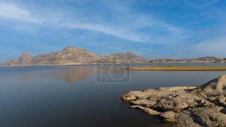 Photo for View of pristine landscape of Jawai Dam with hills and clouds in the background - Royalty Free Image