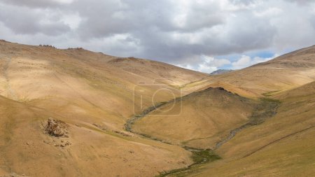 An Abstract landscape of Ladakh with brown pastures and clouds