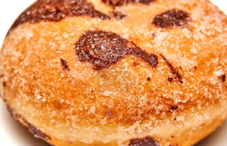 Photo for Close-up of a sugar-crusted bun with chocolate swirls. Selective focus. - Royalty Free Image