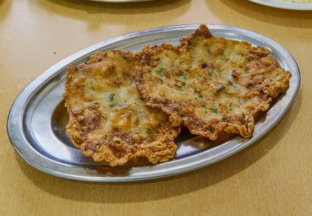 Photo for A "tapa" consisting of two shrimp pancakes, very typical along the Andalusian coast (Spain). - Royalty Free Image